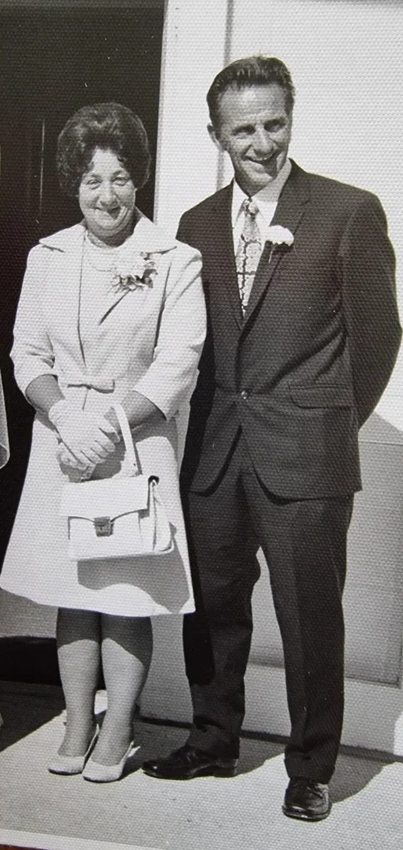 Black and white photograph of Nana Dunn and Uncle Ross, dressed up and smiling