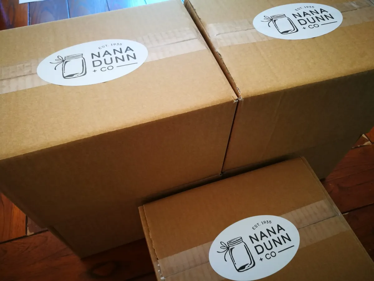 Cardboard boxes sealed with Nana Dunn + Co stickers